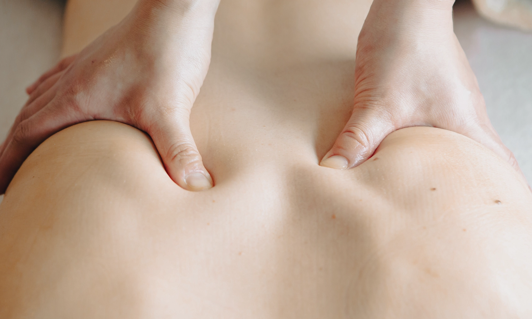 Close-up of firm thumb pressure during deep tissue massage at Oriest Kyoto